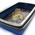 baño con rejilla para conejo